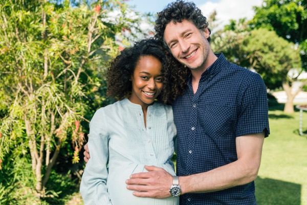 man and pregnant woman in the garden 