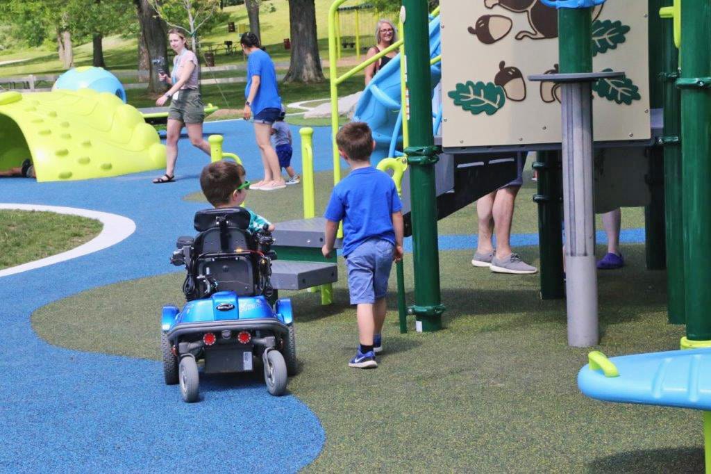 Two children enjoying a Genisys Credit Union sponsored inclusive park