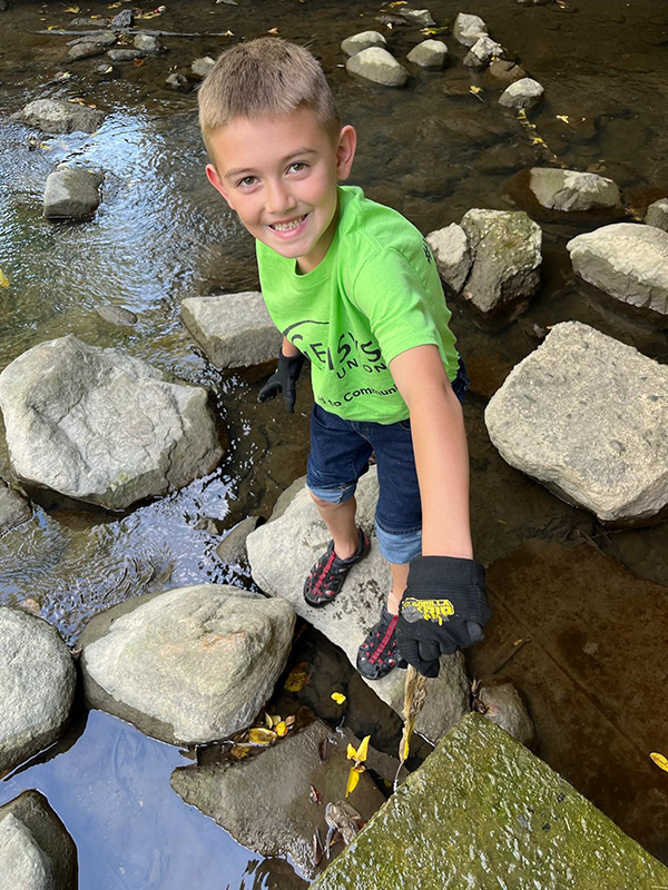 volunteer helping clean up a river