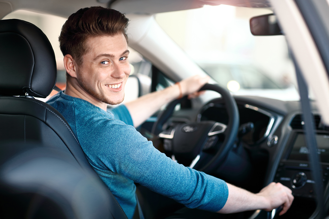 image of man in drivers seat of car