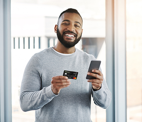 man holding credit card and smartphone