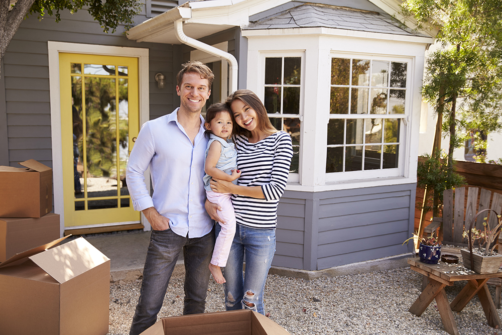 couple standing in front of house