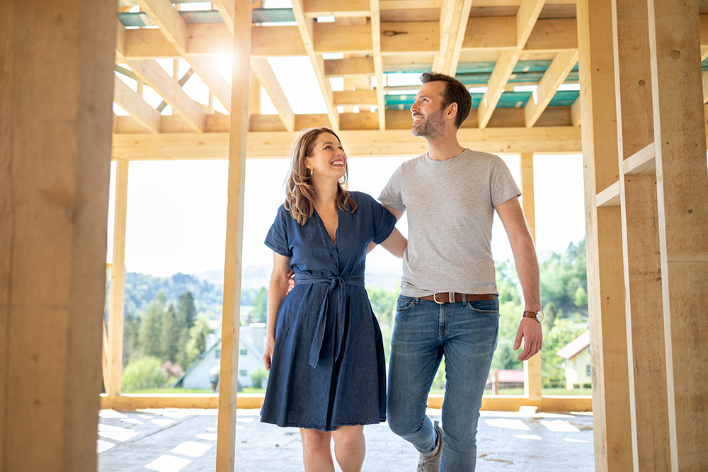 couple looking at their new home being built