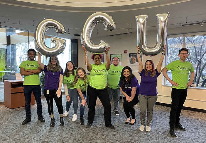 group of employees holding GCU balloons