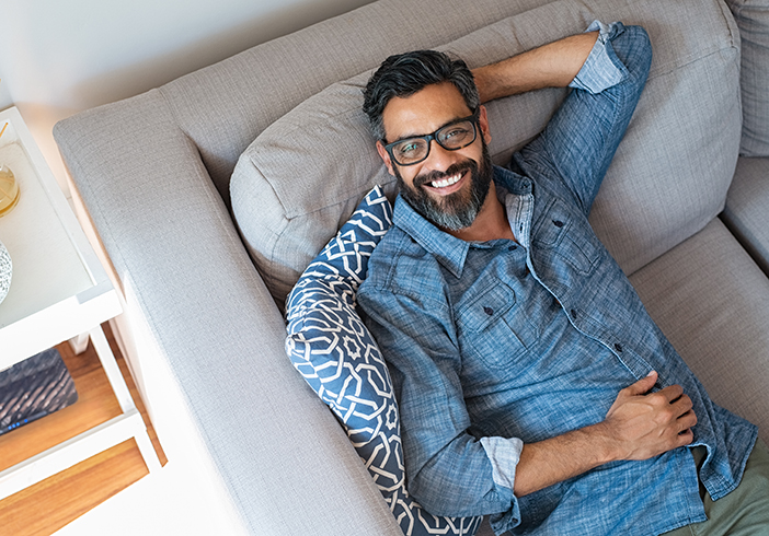 man relaxing on couch