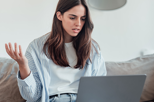 Woman looking at computer, confused