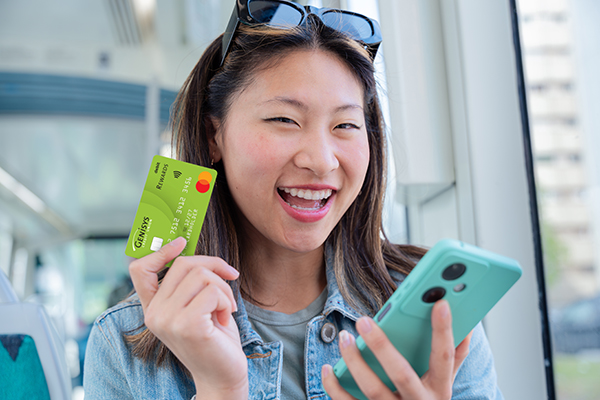 Young woman with credit card, holding cell phone