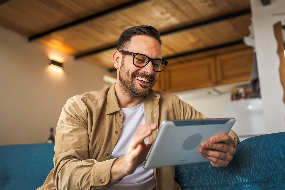 Man sitting at home using a tablet device