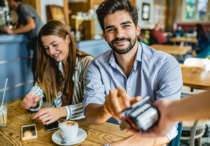 man paying with smartphone