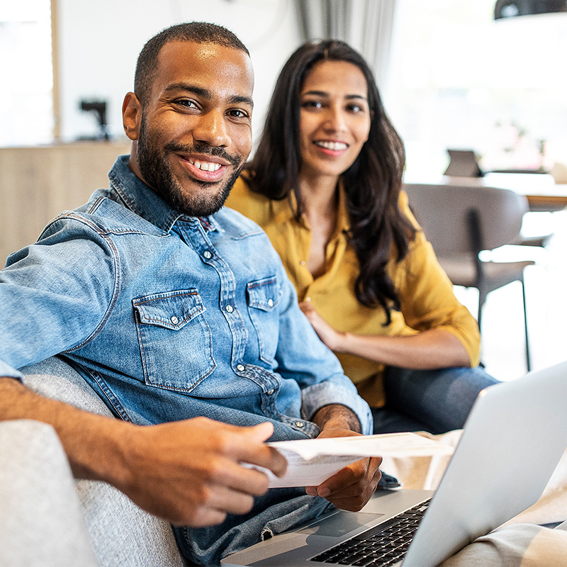 couple sitting with a laptop and documents
