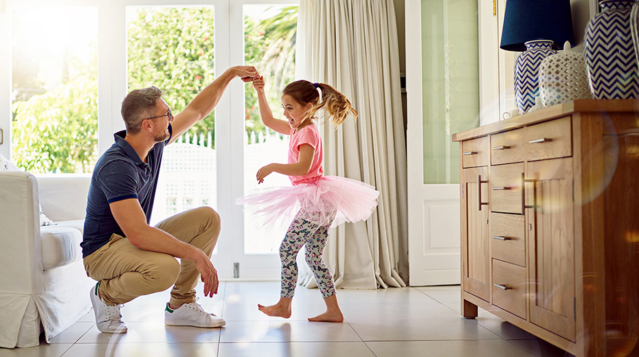 dad and daughter dancing in their home
