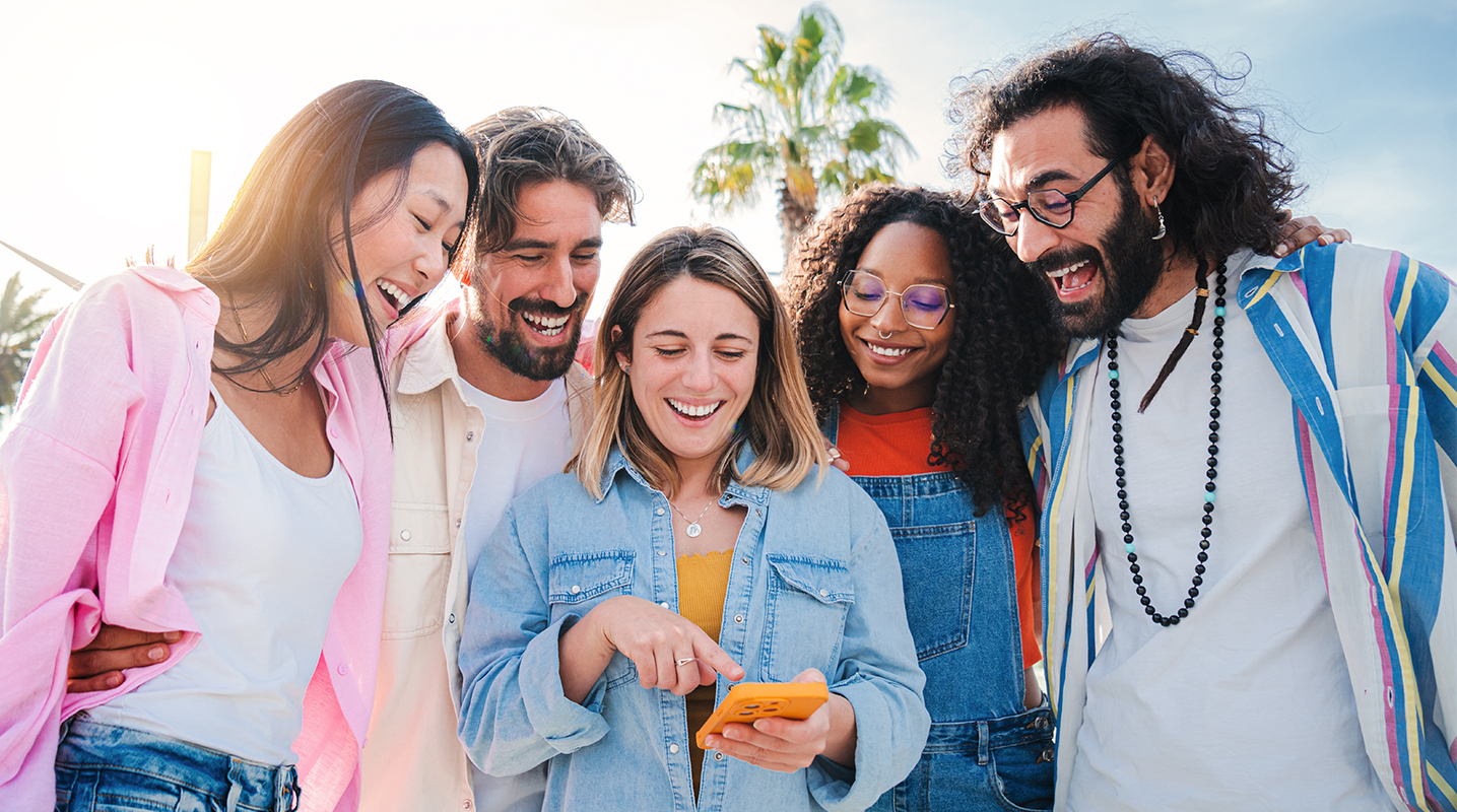 Five friends looking at a phone