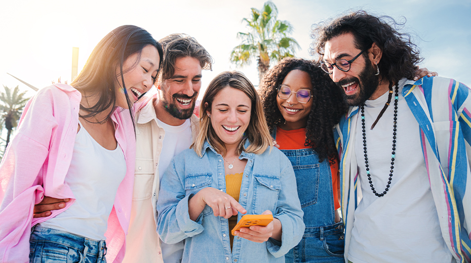 Five friends looking at a phone
