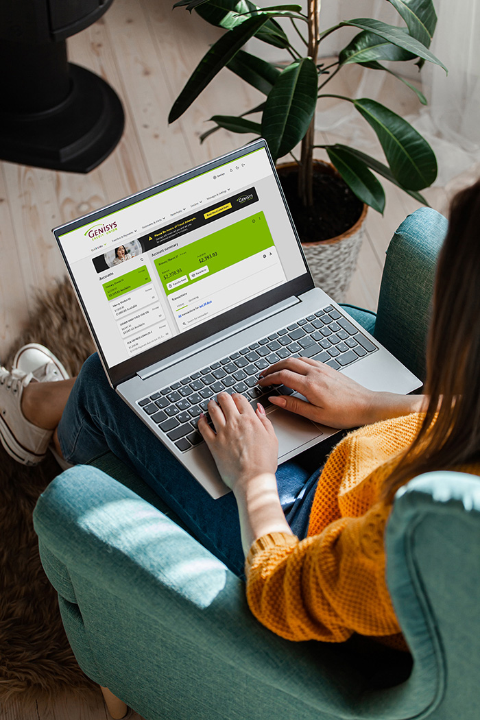 woman using genisys online banking on her laptop