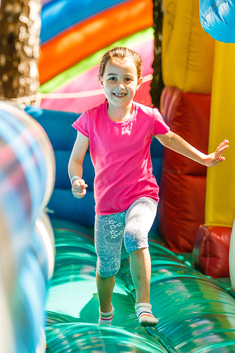 little girl bouncing through bounce house