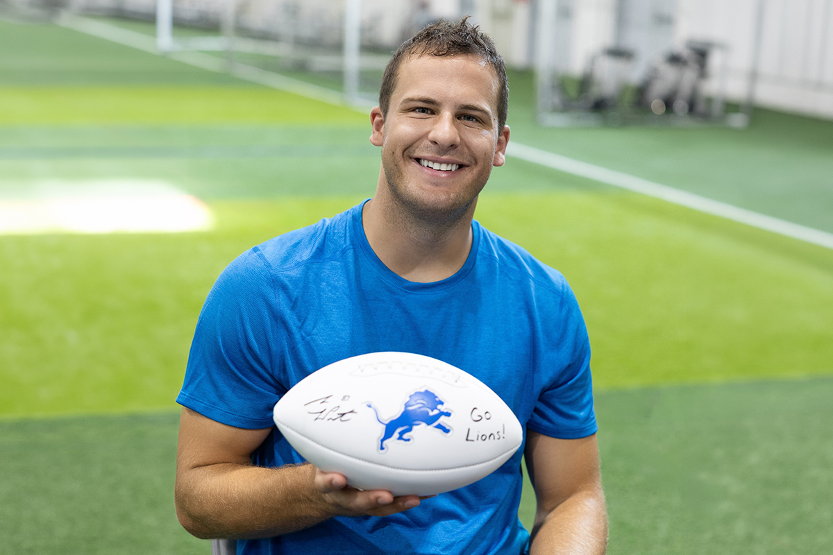 Sam LaPorta holding his autographed football
