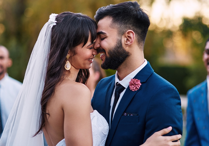 A bride and groom facing each other at the wedding ceremony