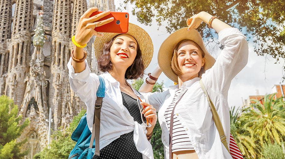 Two women in Spain taking a selfie in front of a cathedral