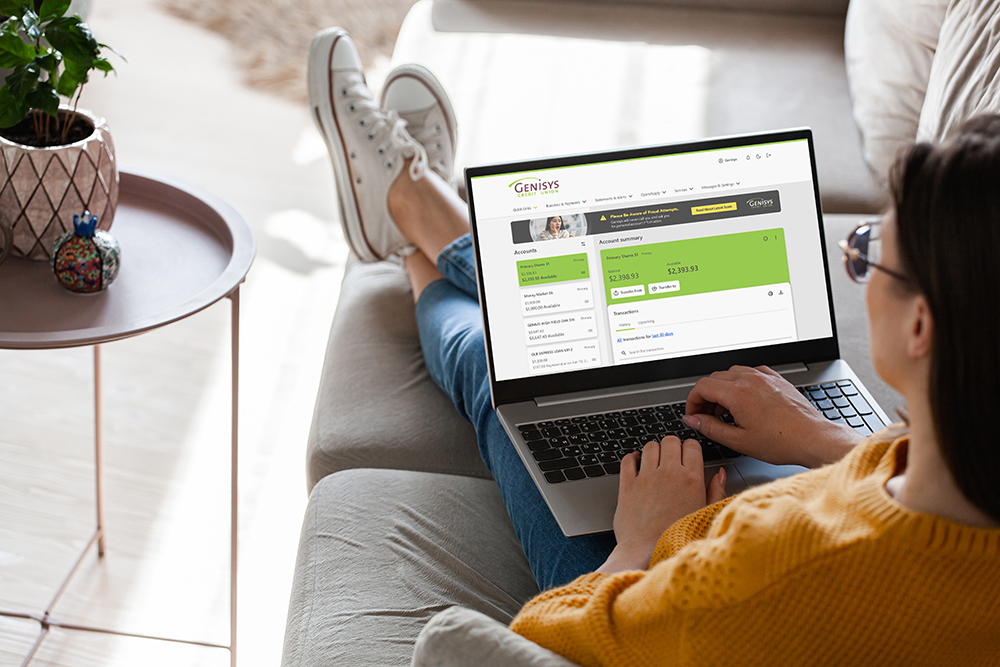 woman using genisys online banking on her laptop